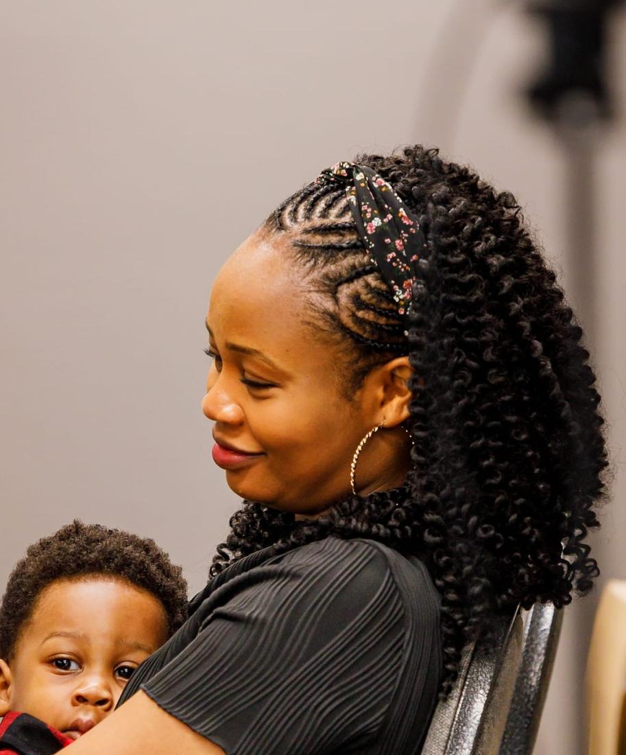 A mother smiling and holding her toddler close, a quiet moment of connection