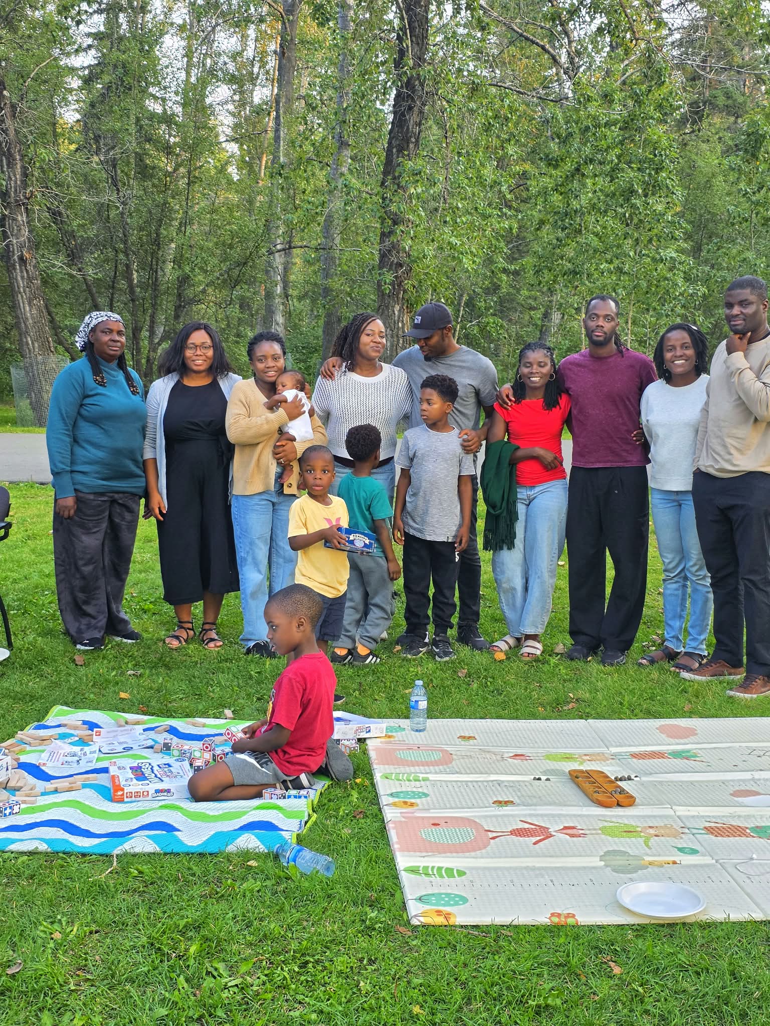 Adejoke Owolabi with family and friends gathered outdoors, representing the connection and intentional relationships at the heart of the Conscious Parent Academy